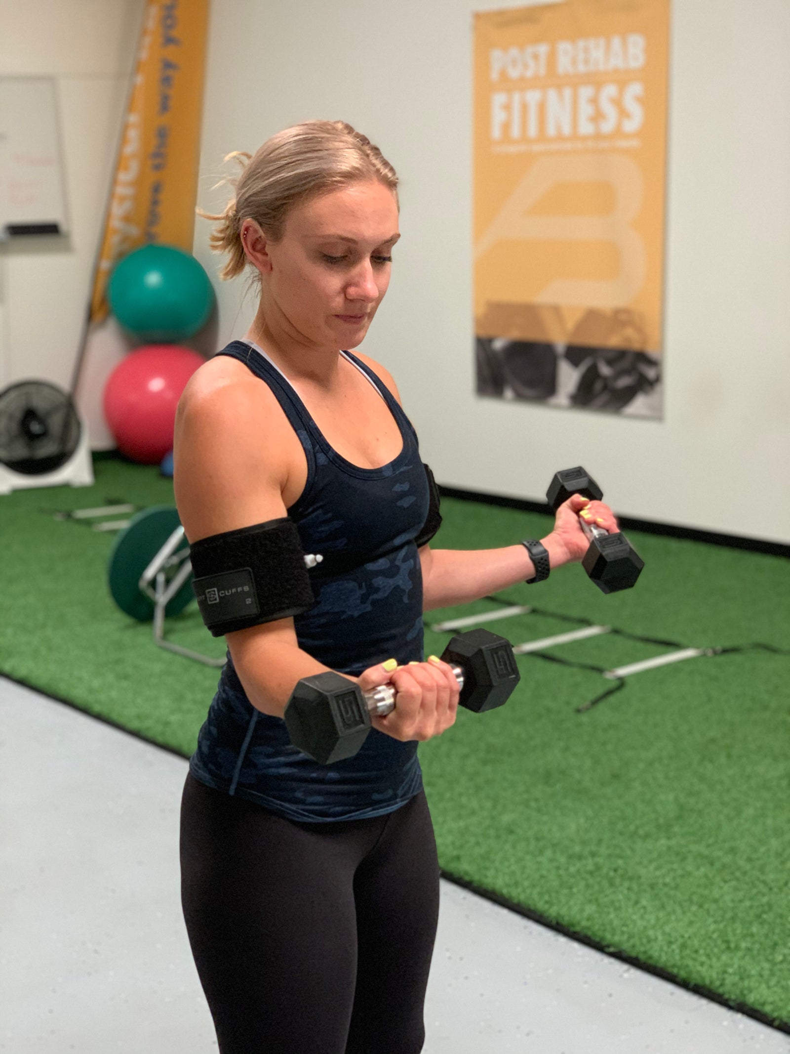 A participant using light weights during a supervised rehabilitation exercise