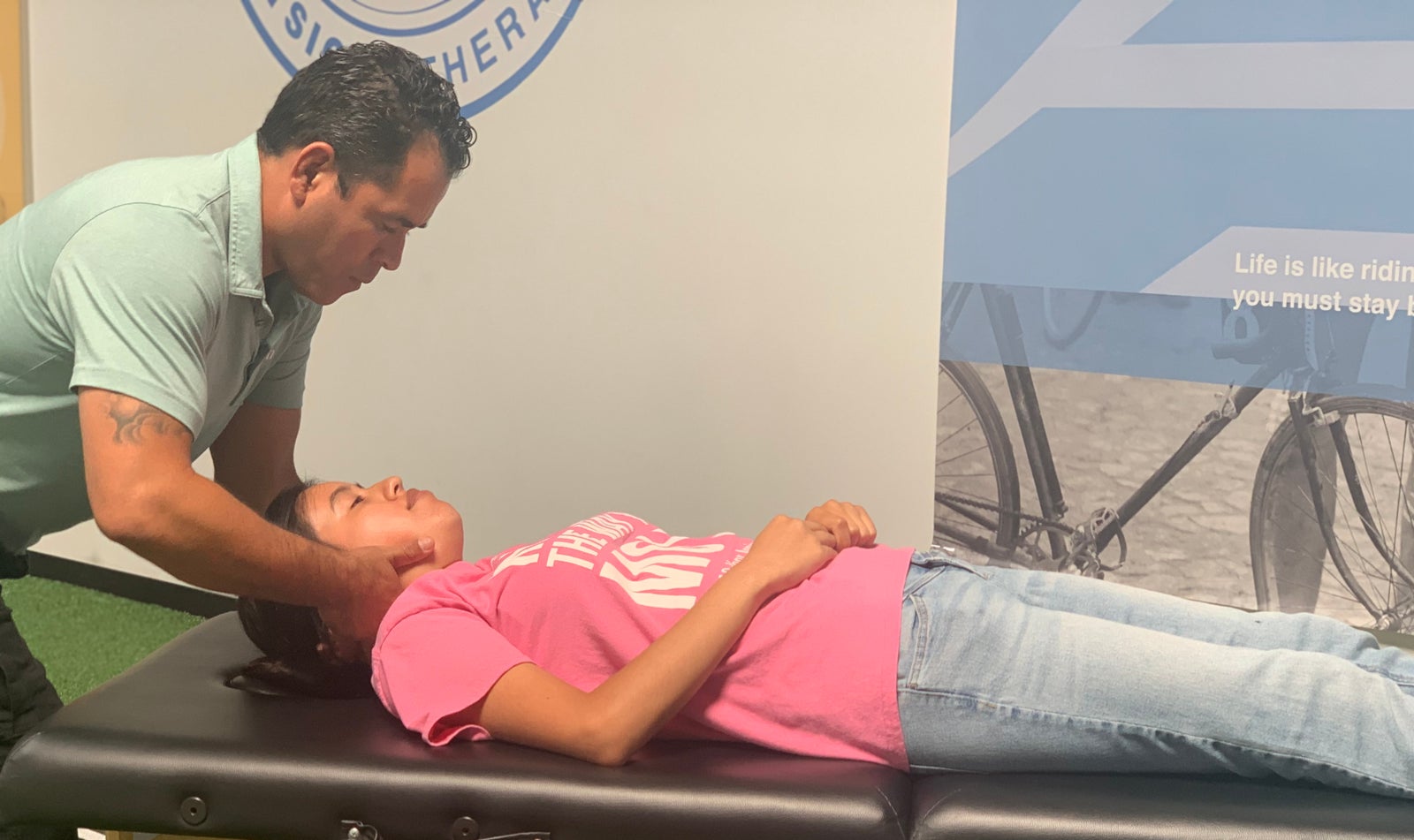A therapist providing hands-on manual care to a patient